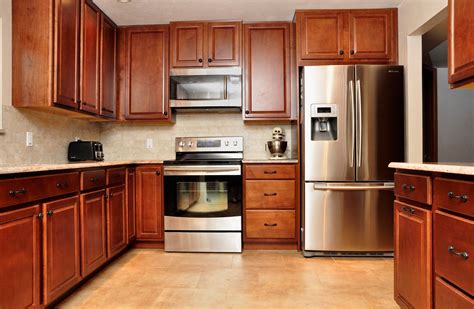 kitchens with dark wood cabinets and stainless steel appliances|dark blue kitchen cabinets.